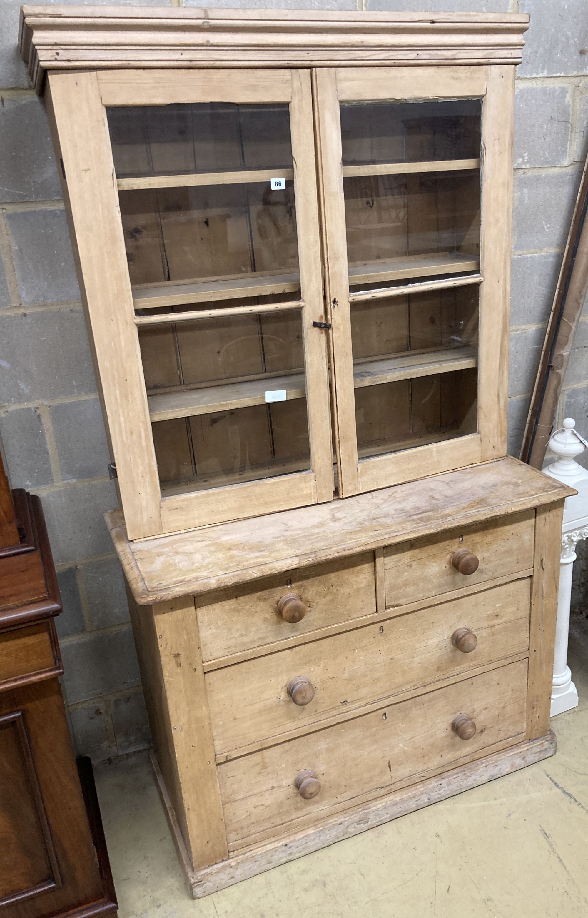 A Victorian glazed pine cabinet on chest, width 112cm, depth 50cm, height 195cm